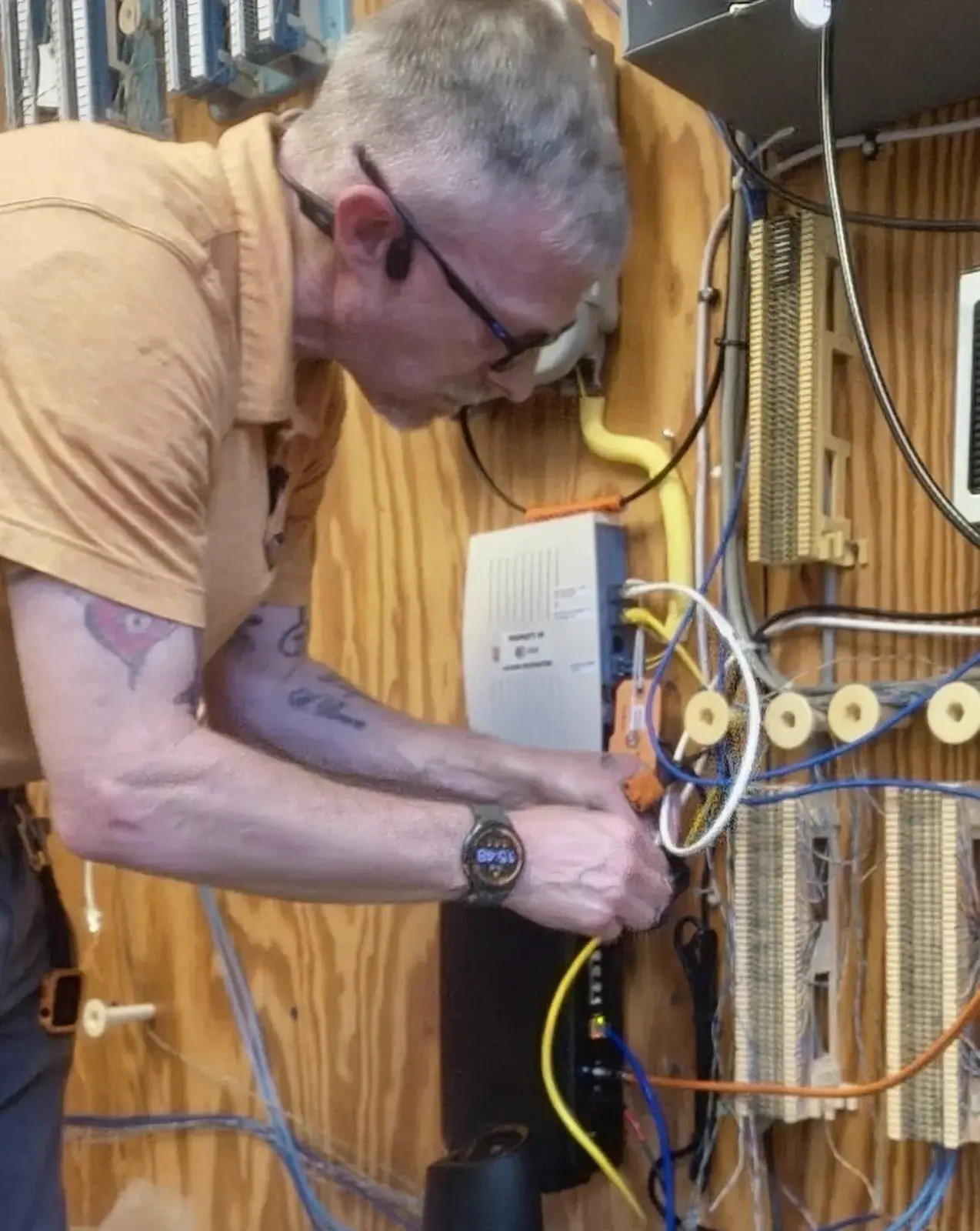 Wesley Dearman performing telecommunications infrastructure punchdown work