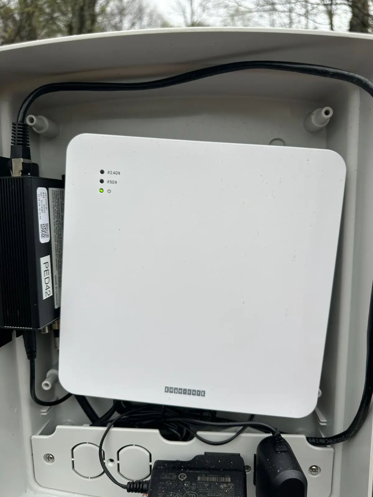 Outdoor enclosure with modem and router hardware