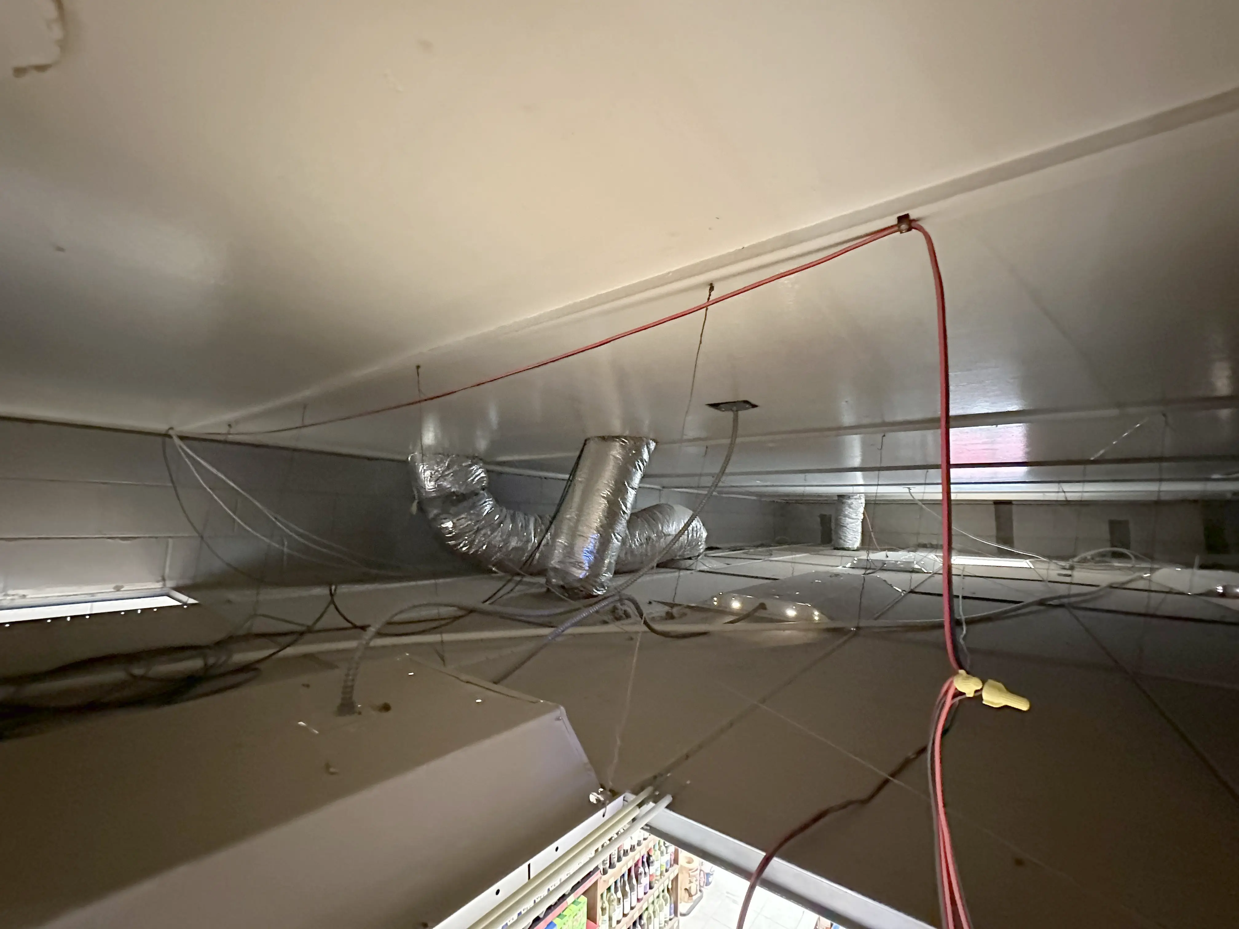 Speaker wire routing above ceiling showing structured cable path and controlled installation detail