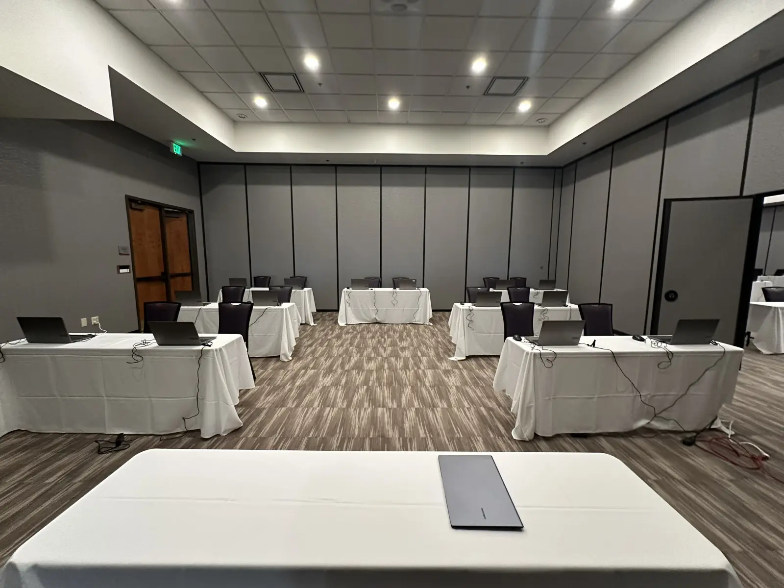 Laptop deployment stations in conference testing environment