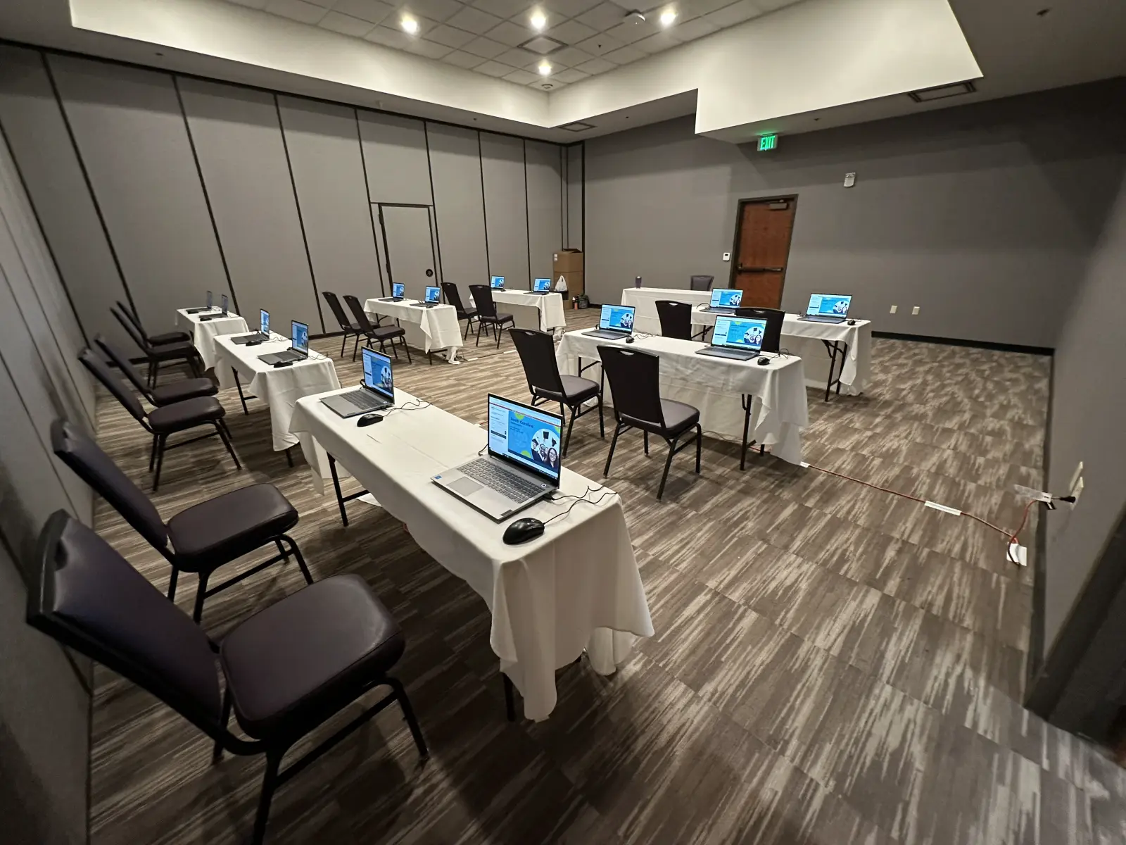 Temporary classroom testing environment with staged laptop stations